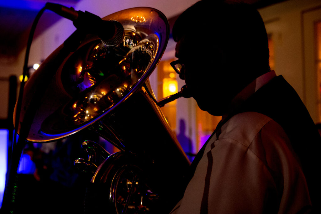 man playing tuba in silhouette