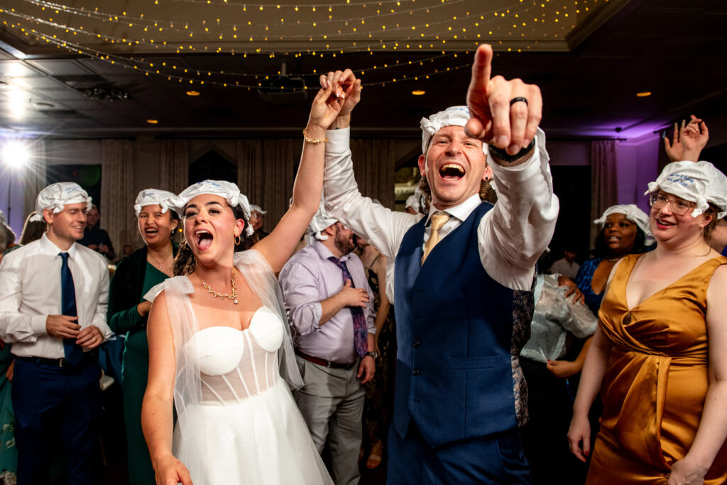 bride and groom laughing and pointing out
