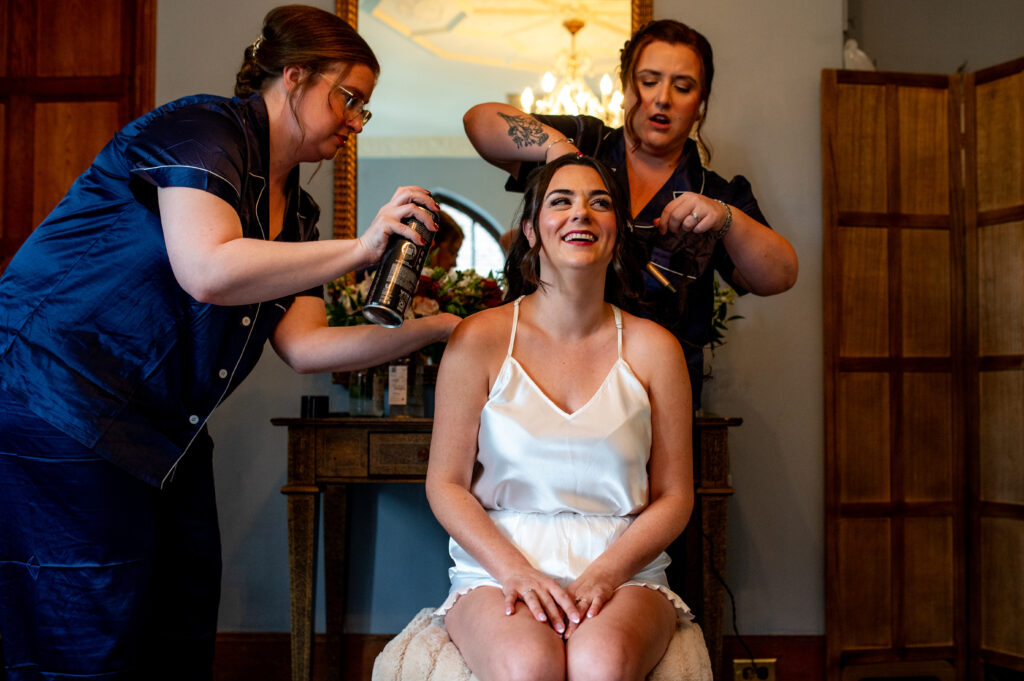 bridesmaids fixing bride's hair