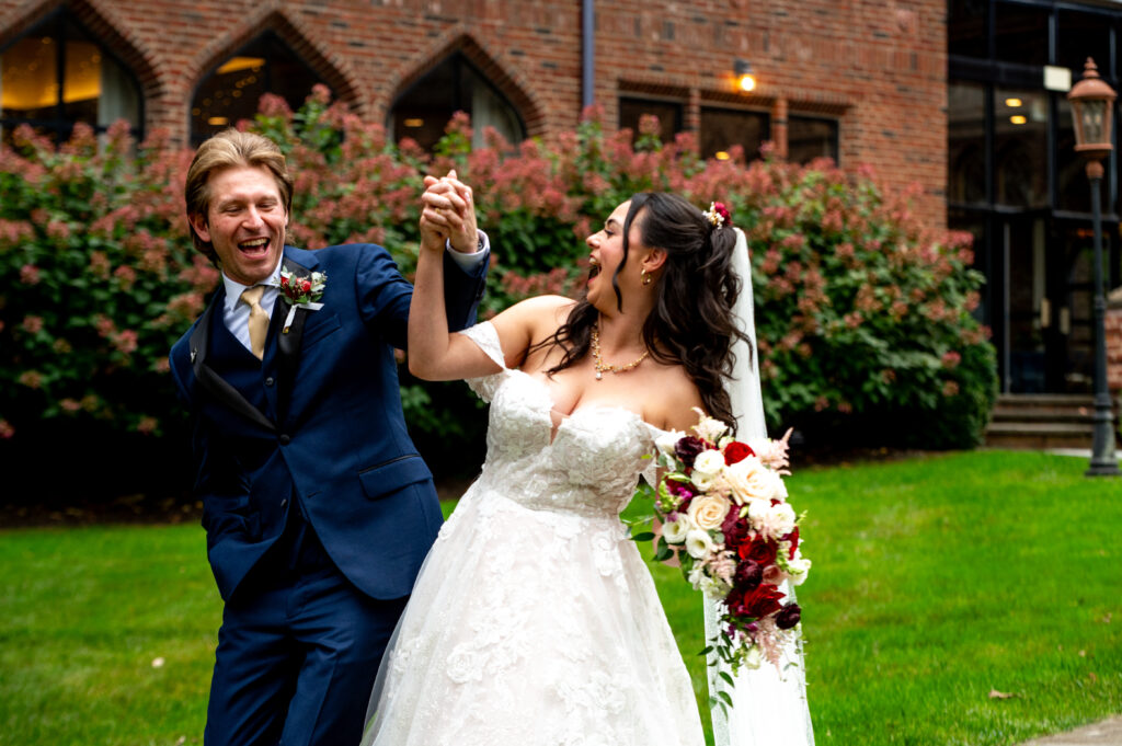 bride and groom bumping hips and laughing