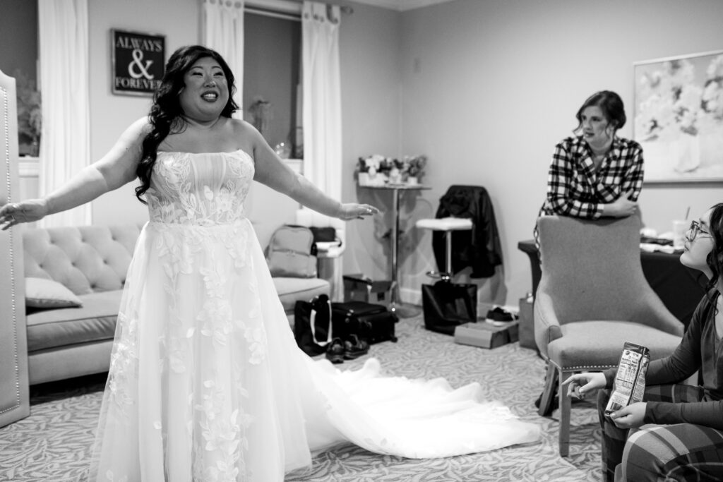 bride standing showing her wedding dress