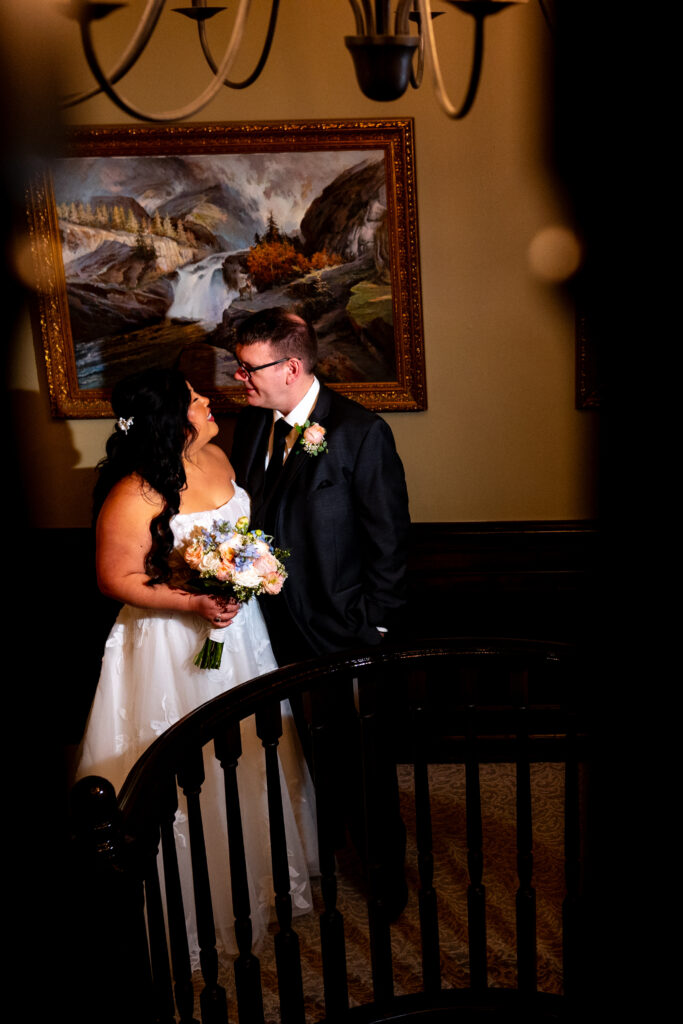 bride and groom posing on staircase