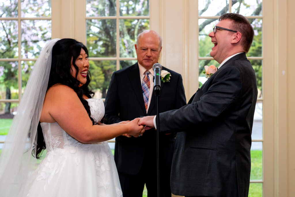 bride and groom laughing while getting married