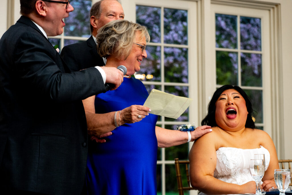 bride laughing as woman gives a speech