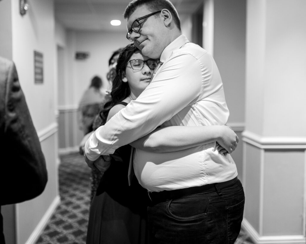 man and girl hugging