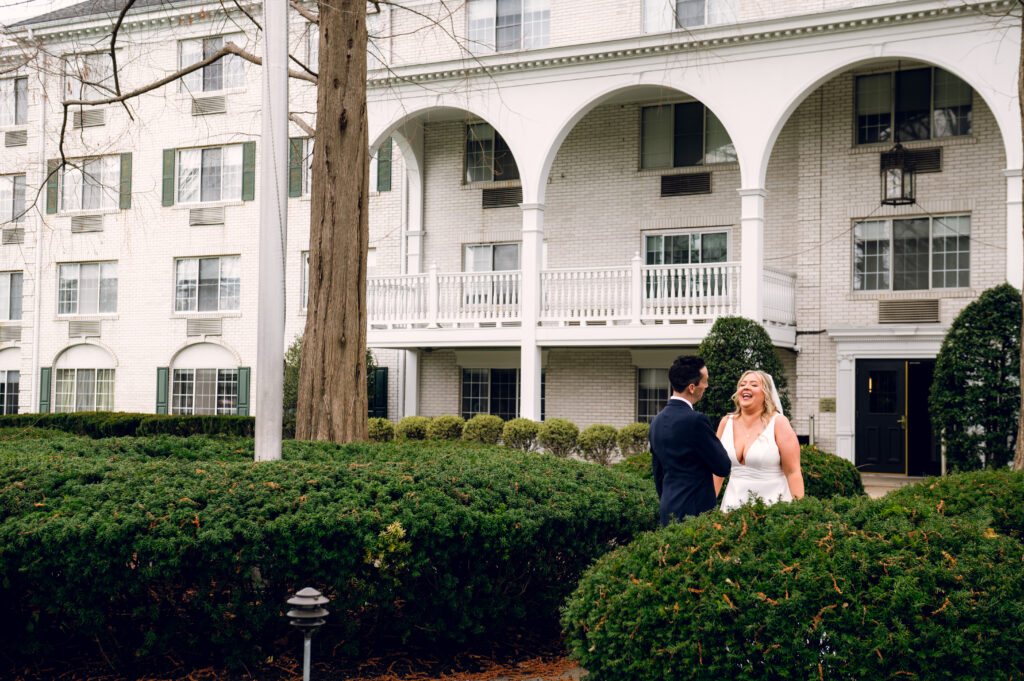 bride and groom standing in greenery
