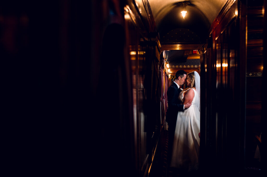 bride and groom embracing in traincar