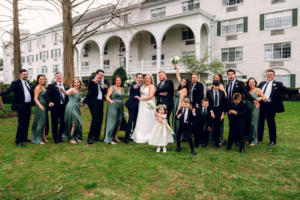 bridal party posing in front of madison hotel