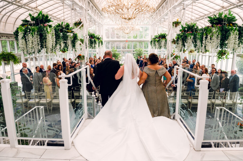 bride walking down the aisle with her parents