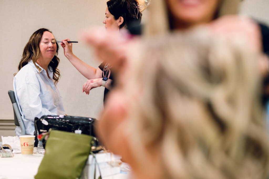 woman getting makeup done
