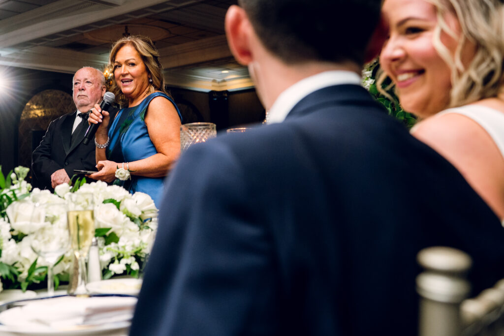 woman giving a speech as bride smiles