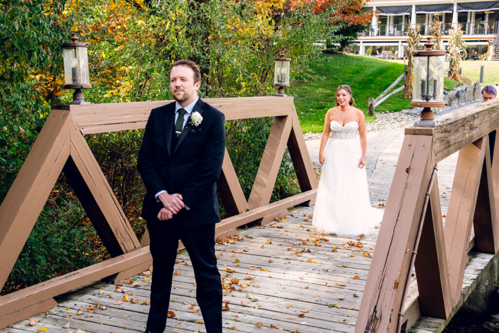 bride walking up to groom for a first look at bear brook valley