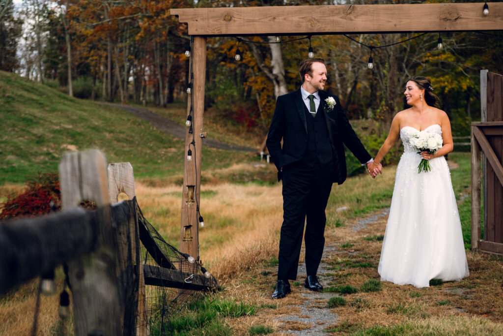 bride and groom holding hands near the wedding venue bear brook valley
